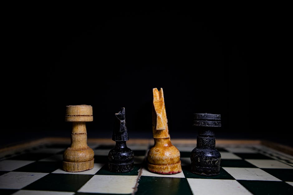 Close-up of rustic chess pieces on a wooden board, highlighting strategy and tactics.